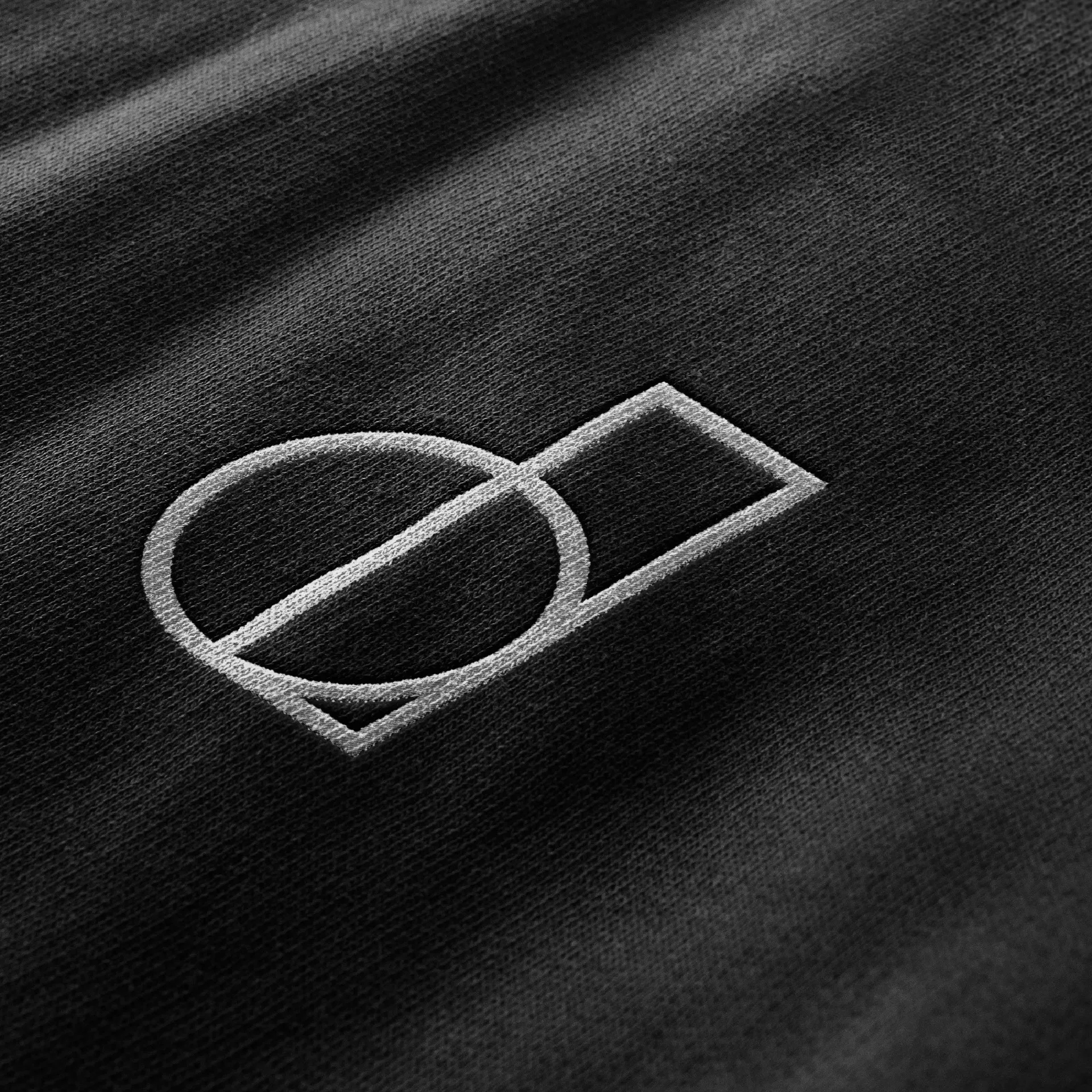 District 150 - Embossed logo on dark textured material