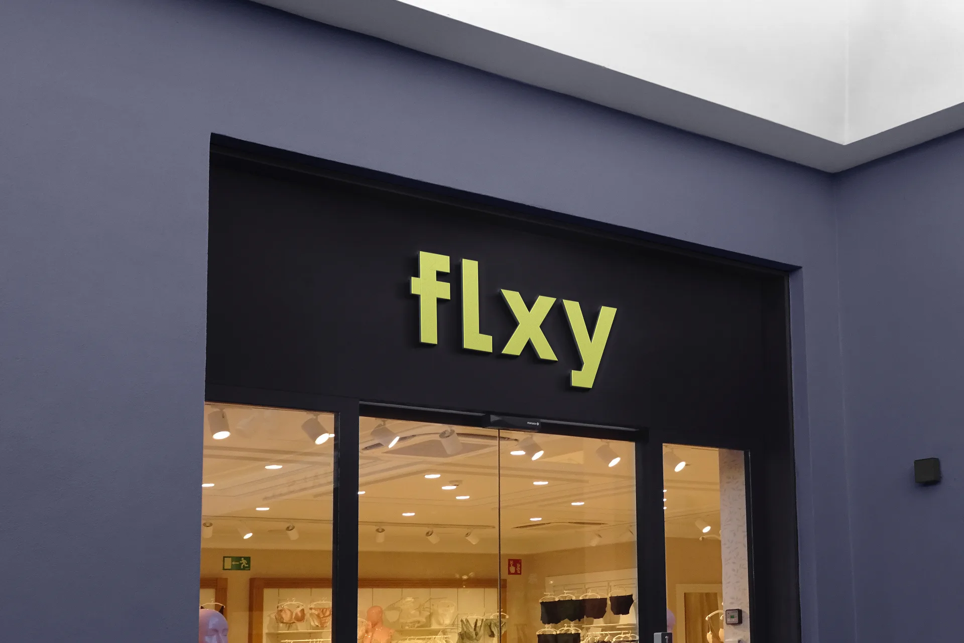 FLXY - Exterior signage with holographic texture and bold branding