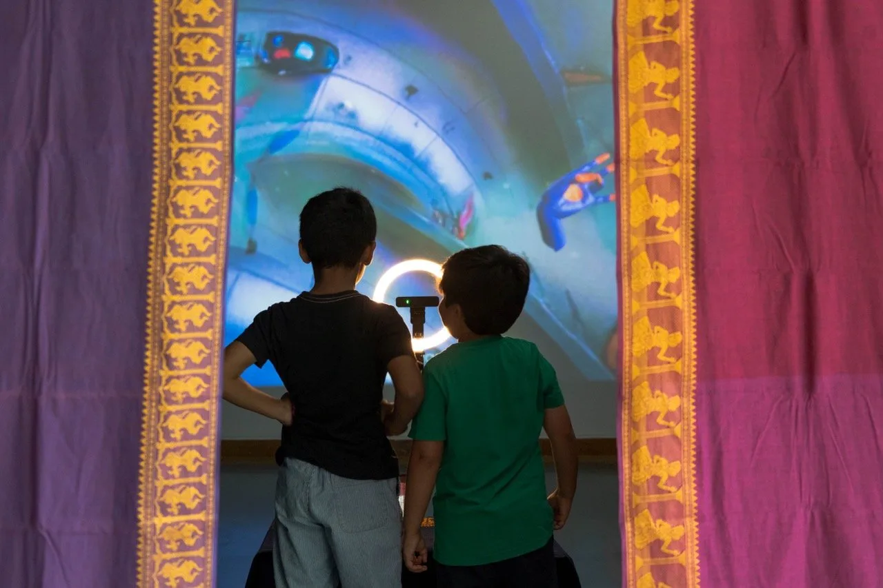 Give Me a Sign - Children interacting with Earth & Water theme through draped entrance