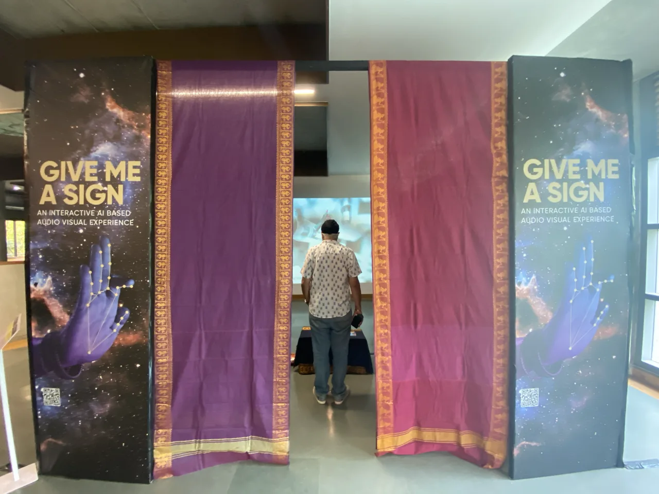 Give Me a Sign - Visitor entering through traditional textile-framed entrance
