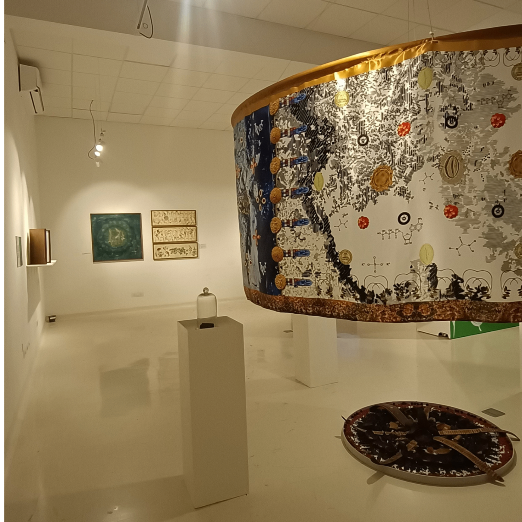 Curved gallery wall displaying interactive Travelling Plants exhibition with botanical mapping and visitor engagement areas